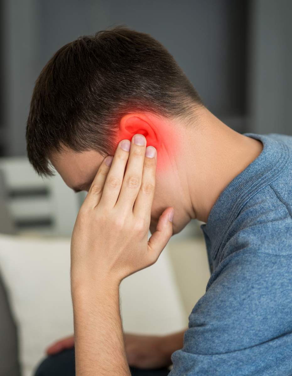 Mann greift sich an sein gerötetes Ohr.